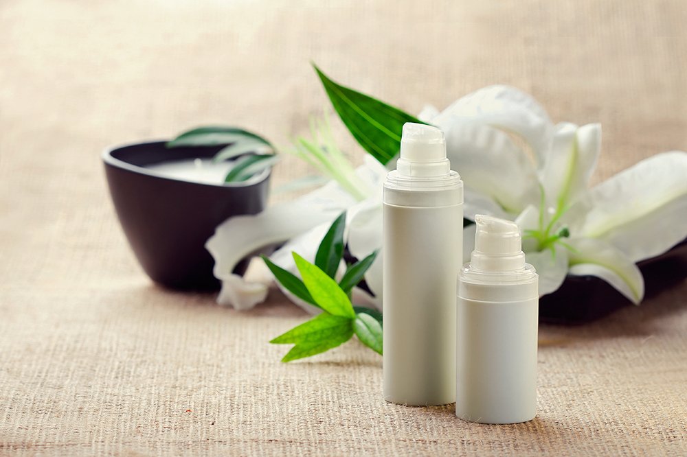 Lotion containers on a styled background