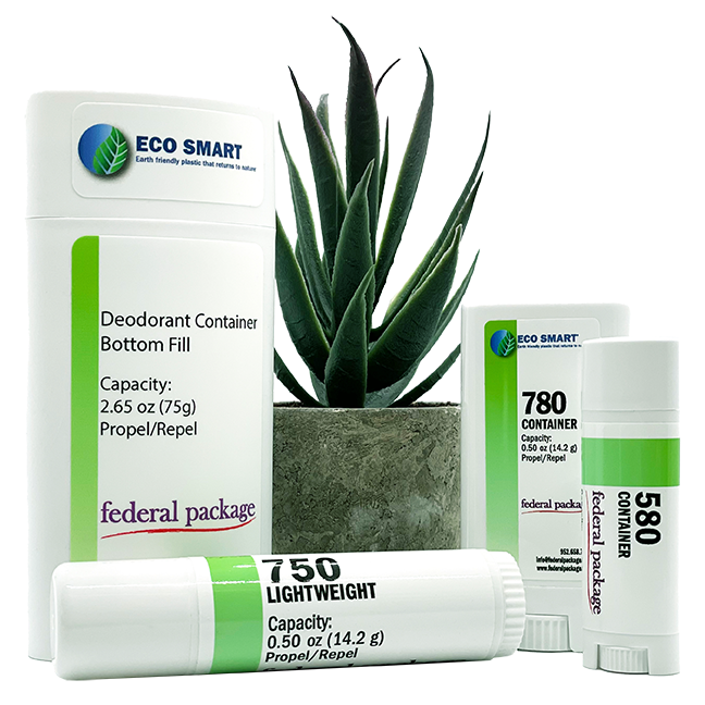 Eco-friendly deodorant containers from the ‘Eco Smart’ line, displayed alongside a potted plant, emphasizing sustainability and green packaging solutions.