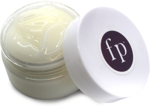 Open jar of lotion with a white lid featuring the ‘fp’ logo, showing the creamy texture of the product inside on a transparent background.