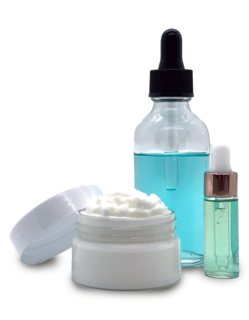 Cosmetic products including a glass dropper bottle filled with blue liquid, a small roller bottle with green liquid, and an open jar of white cream on a transparent background.