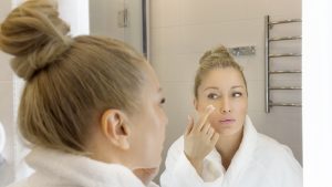 woman using skincare formula