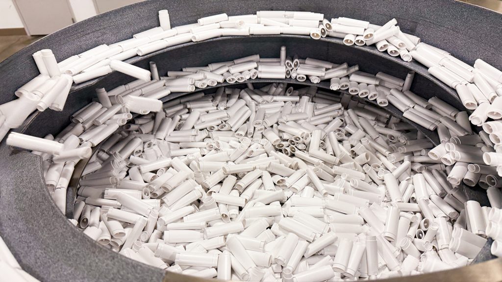 containers in a stainless steel sorting drum