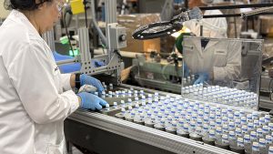 lip balm products on an assembly line